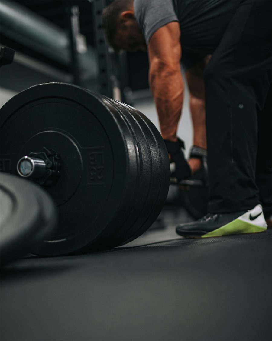 Athlete setting up a loaded barbell for a deadlift