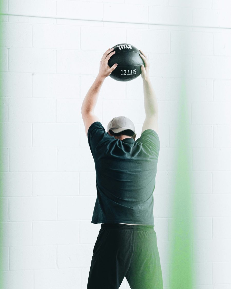 Athlete doing an overhead medicine ball exercise